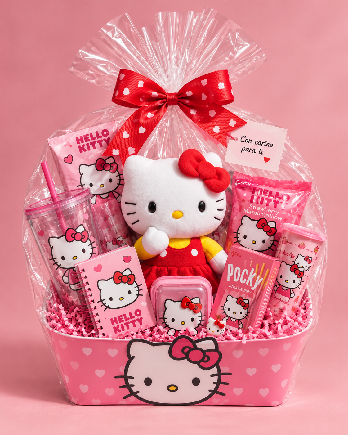 Wrapped Hello Kitty gift basket with a plush toy, tumbler, notebook, pink treats, and red bow